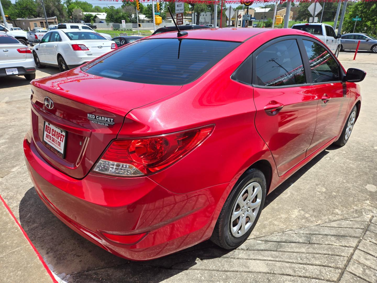 2014 Red Hyundai Accent GLS 4-Door (KMHCT4AE9EU) with an 1.6L L4 DOHC 16V engine, Automatic transmission, located at 503 West Court, Seguin, TX, 78155, (830) 379-3373, 29.568621, -97.969803 - Photo#2